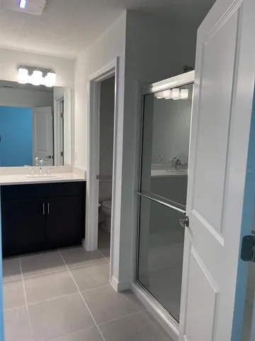 a bathroom with a sink a mirror and a shower