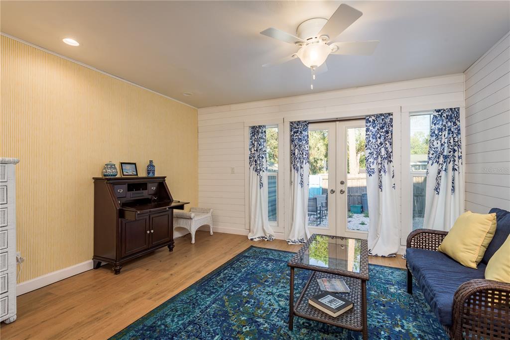 102 Anclote Road Tarpon Springs, FL 34689 - Photo 11 of 42 a living room with furniture and wooden floor