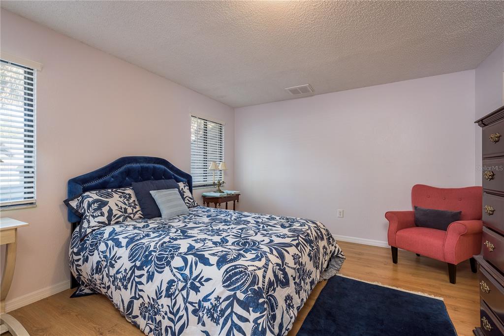 102 Anclote Road Tarpon Springs, FL 34689 - Photo 19 of 42 a bedroom with a bed and a couch