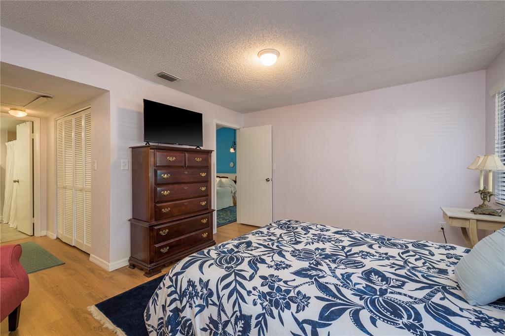 102 Anclote Road Tarpon Springs, FL 34689 - Photo 20 of 42 a bedroom with a bed and a television