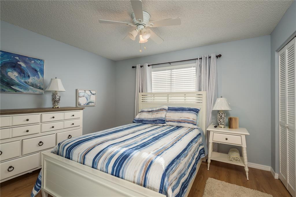 102 Anclote Road Tarpon Springs, FL 34689 - Photo 23 of 42 a bedroom with a large bed and a window