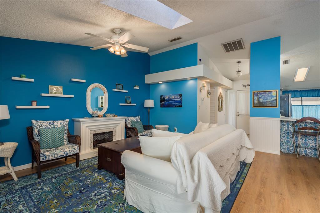 102 Anclote Road Tarpon Springs, FL 34689 - Photo 9 of 42 a living room with furniture and a fireplace