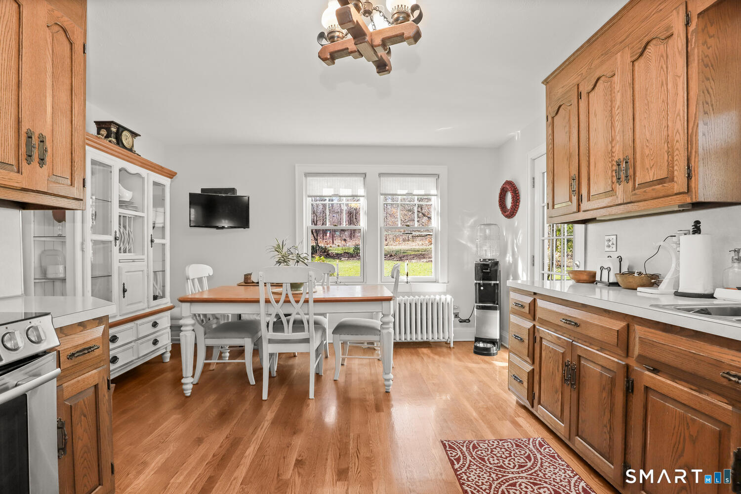 4 Kay Lane Newtown, CT 06470 - Photo 11 of 38 a living room with furniture a dining table wooden floor and a large window