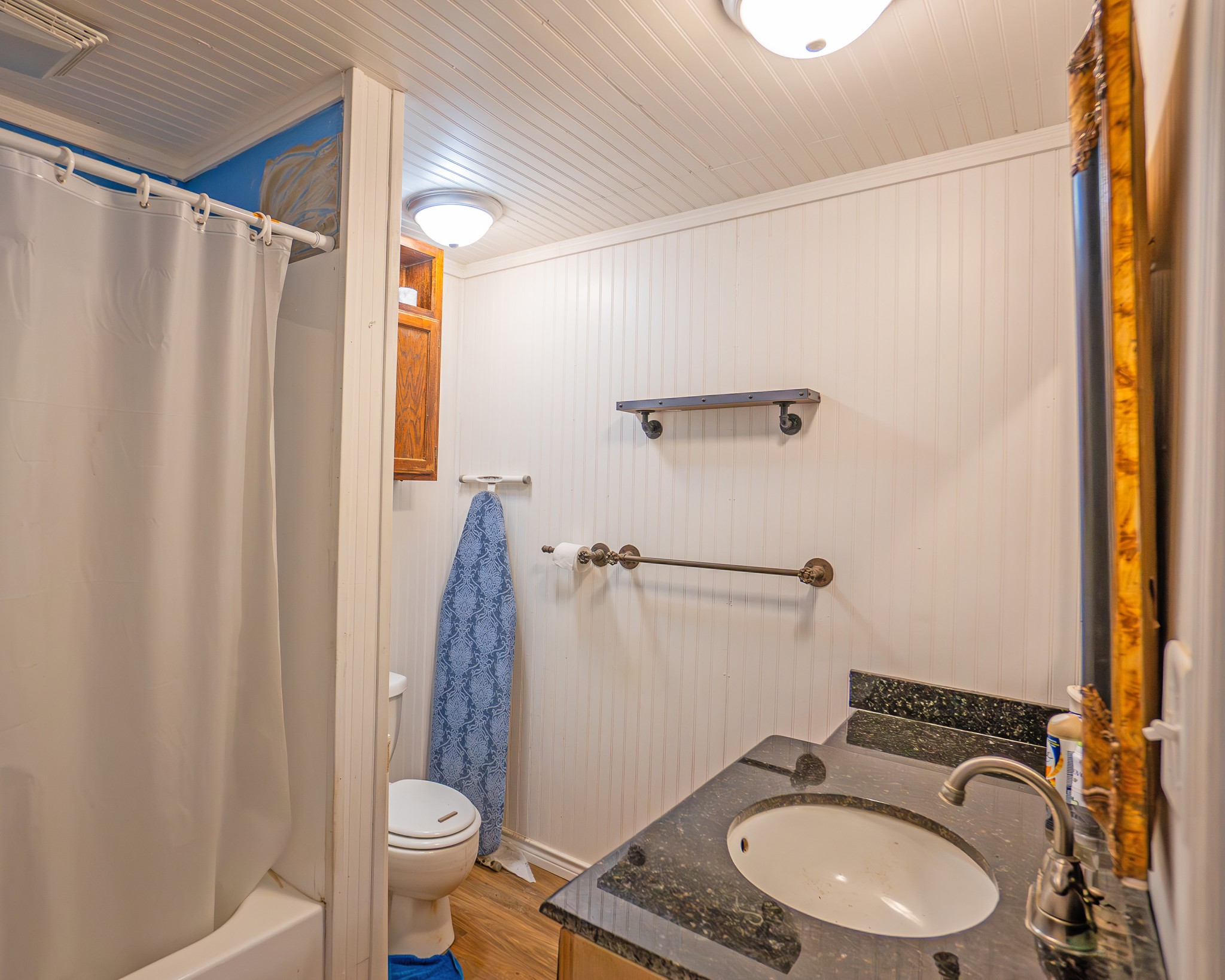 214 Williams Road Bay City, TX 77414 - Photo 16 of 48 a bathroom with a sink a toilet a mirror and shower curtain
