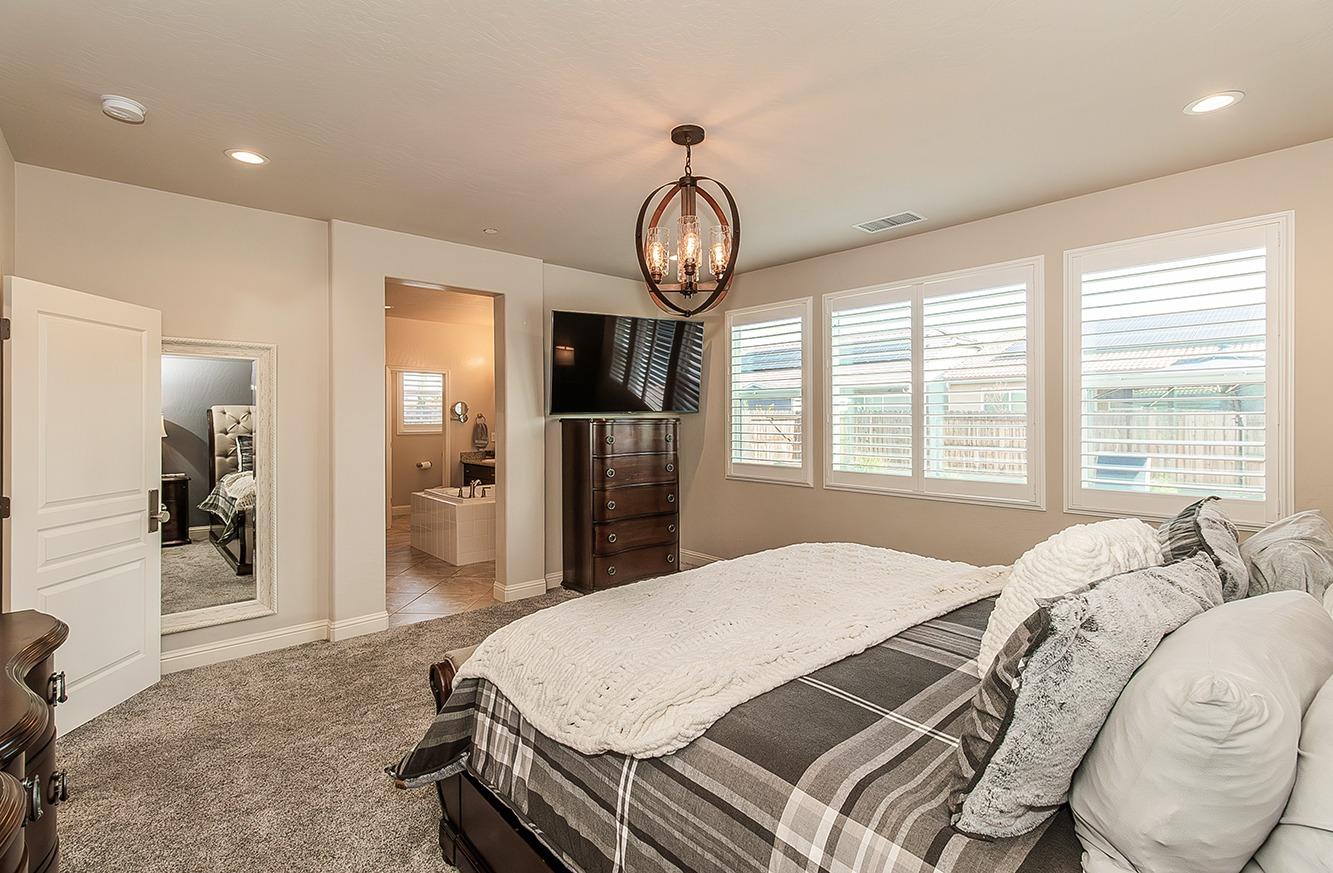 1035 Agua Dulce Avenue Clovis, CA 93619 - Photo 16 of 40 a bed sitting in a spacious bedroom next to a window