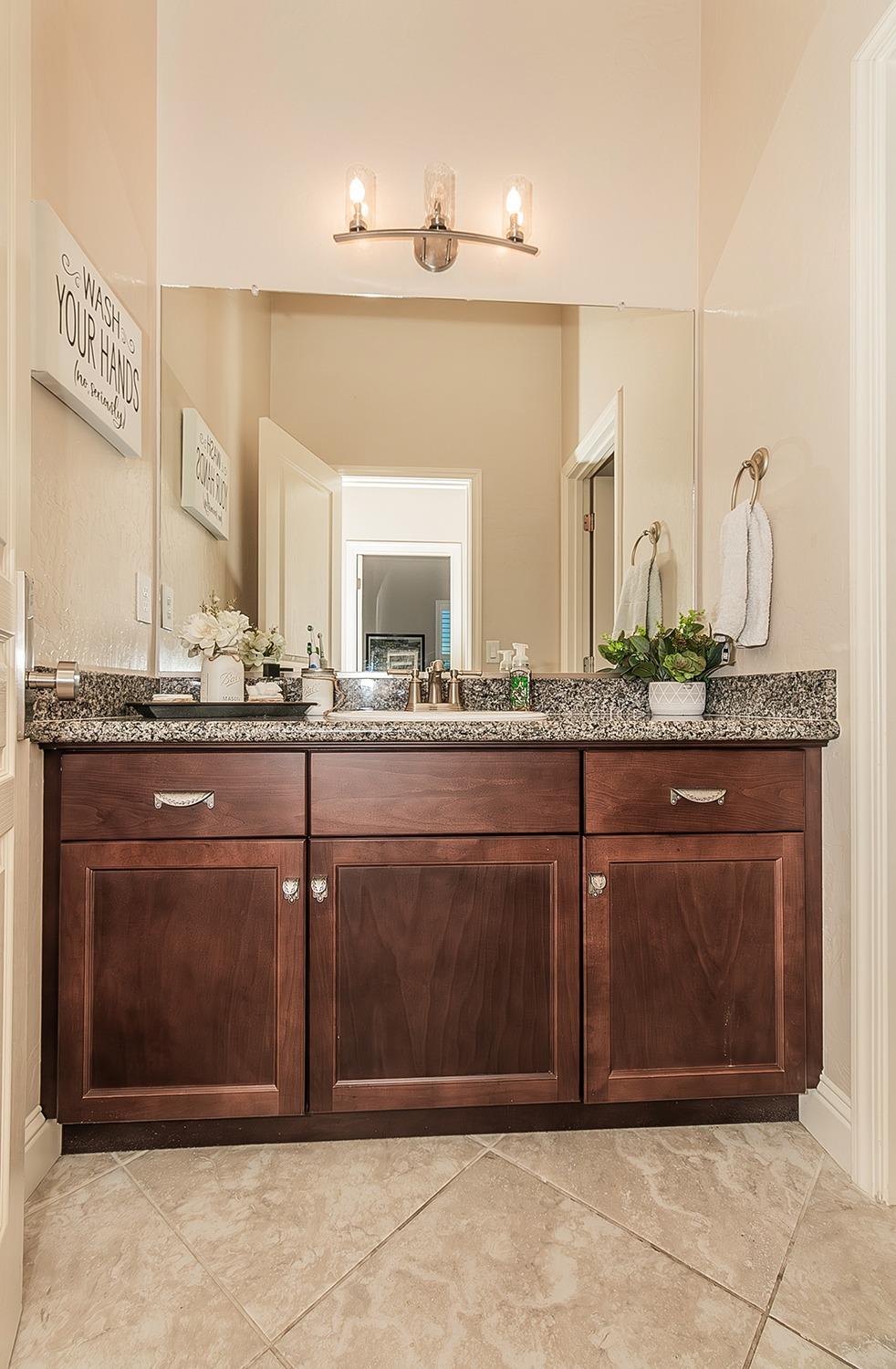 1035 Agua Dulce Avenue Clovis, CA 93619 - Photo 23 of 40 a bathroom with a sink and a mirror
