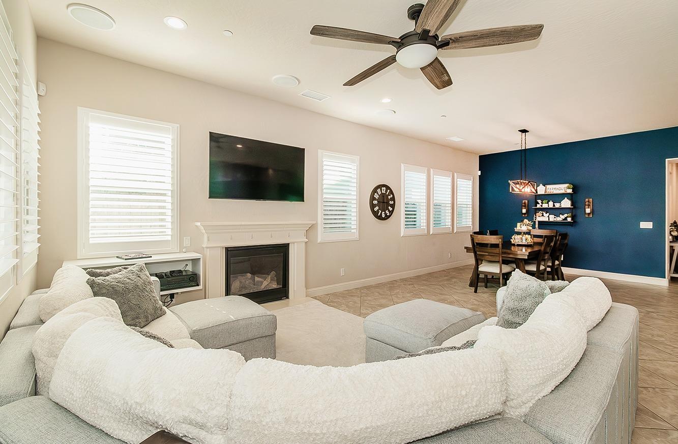 1035 Agua Dulce Avenue Clovis, CA 93619 - Photo 8 of 40 a living room with furniture a fireplace and a flat screen tv