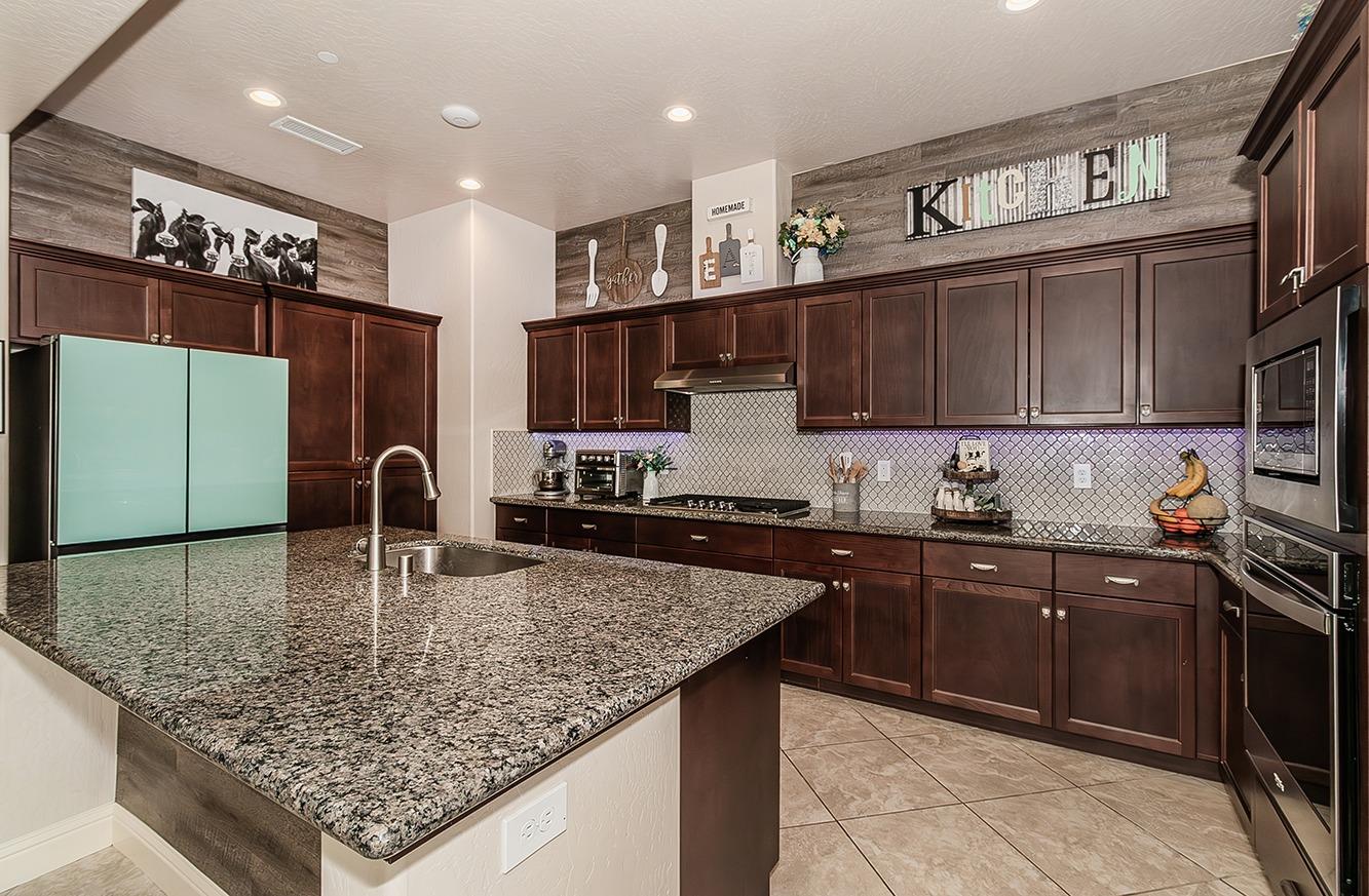 1035 Agua Dulce Avenue Clovis, CA 93619 - Photo 10 of 40 a kitchen with stainless steel appliances granite countertop a sink counter space and cabinets