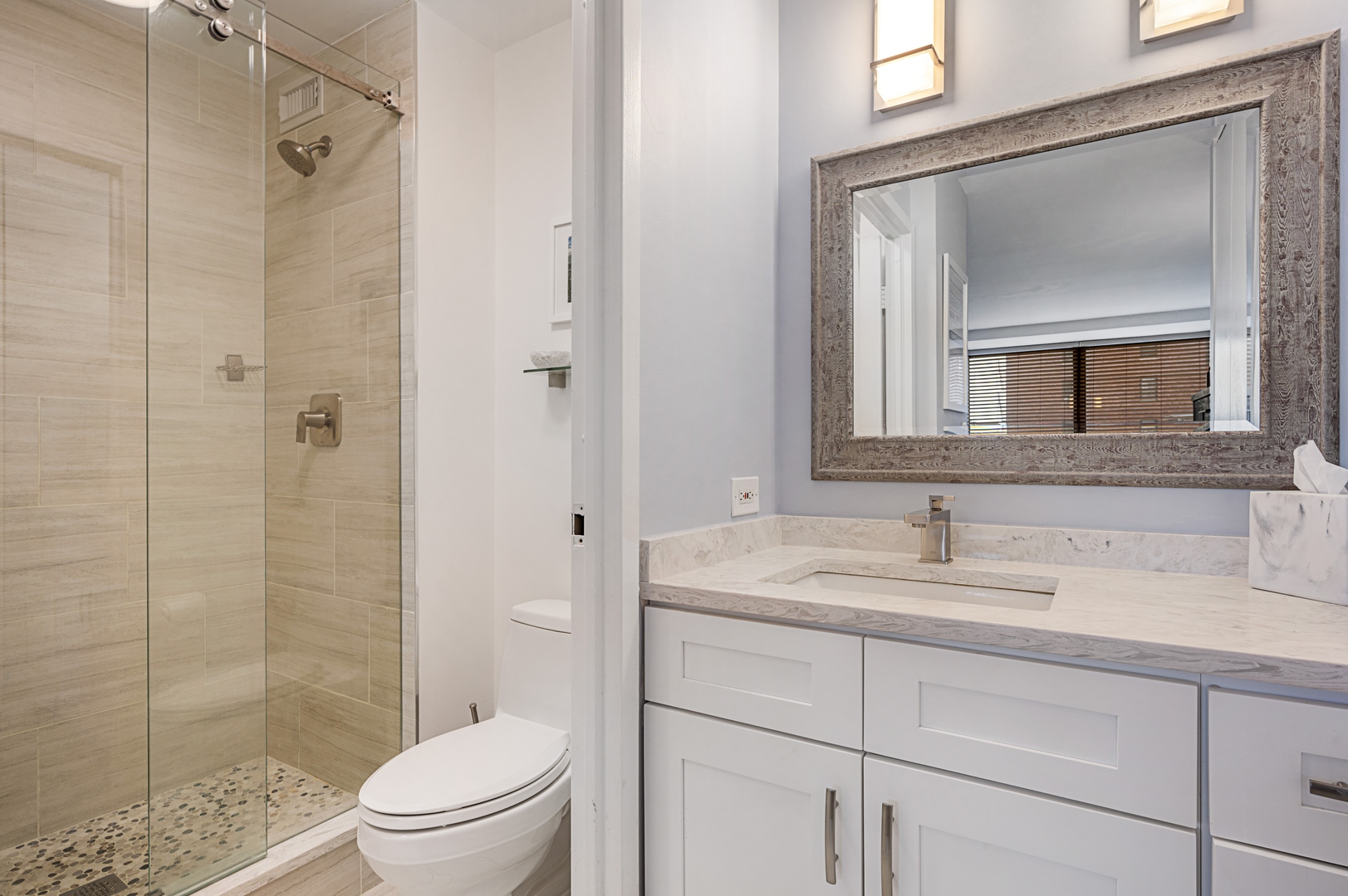 3150 North Sheridan Road, Unit 3C Chicago, IL 60657 - Photo 11 of 19 a bathroom with a toilet sink vanity and shower