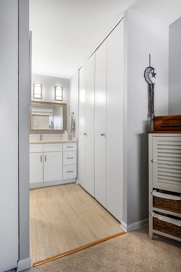 3150 North Sheridan Road, Unit 3C Chicago, IL 60657 - Photo 12 of 19 a view of a kitchen with white cabinets and wooden floor