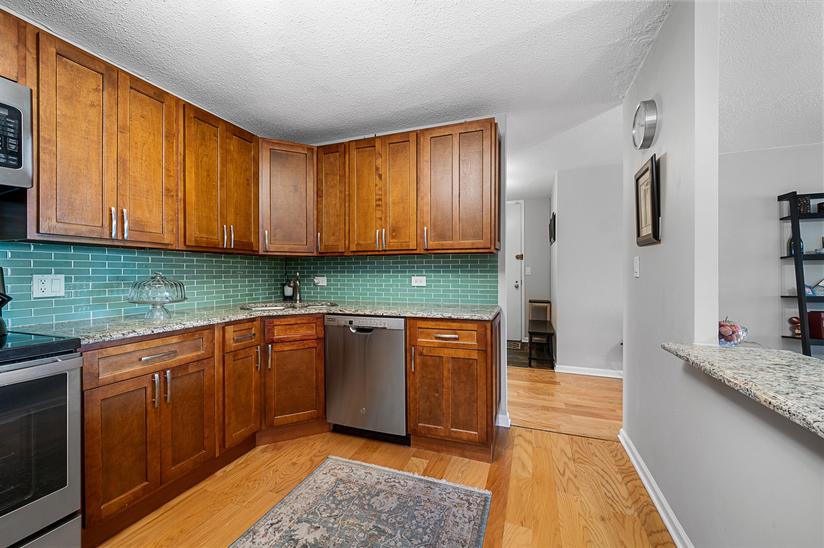 3150 North Sheridan Road, Unit 3C Chicago, IL 60657 - Photo 7 of 19 a kitchen with stainless steel appliances granite countertop wooden cabinets a sink and dishwasher