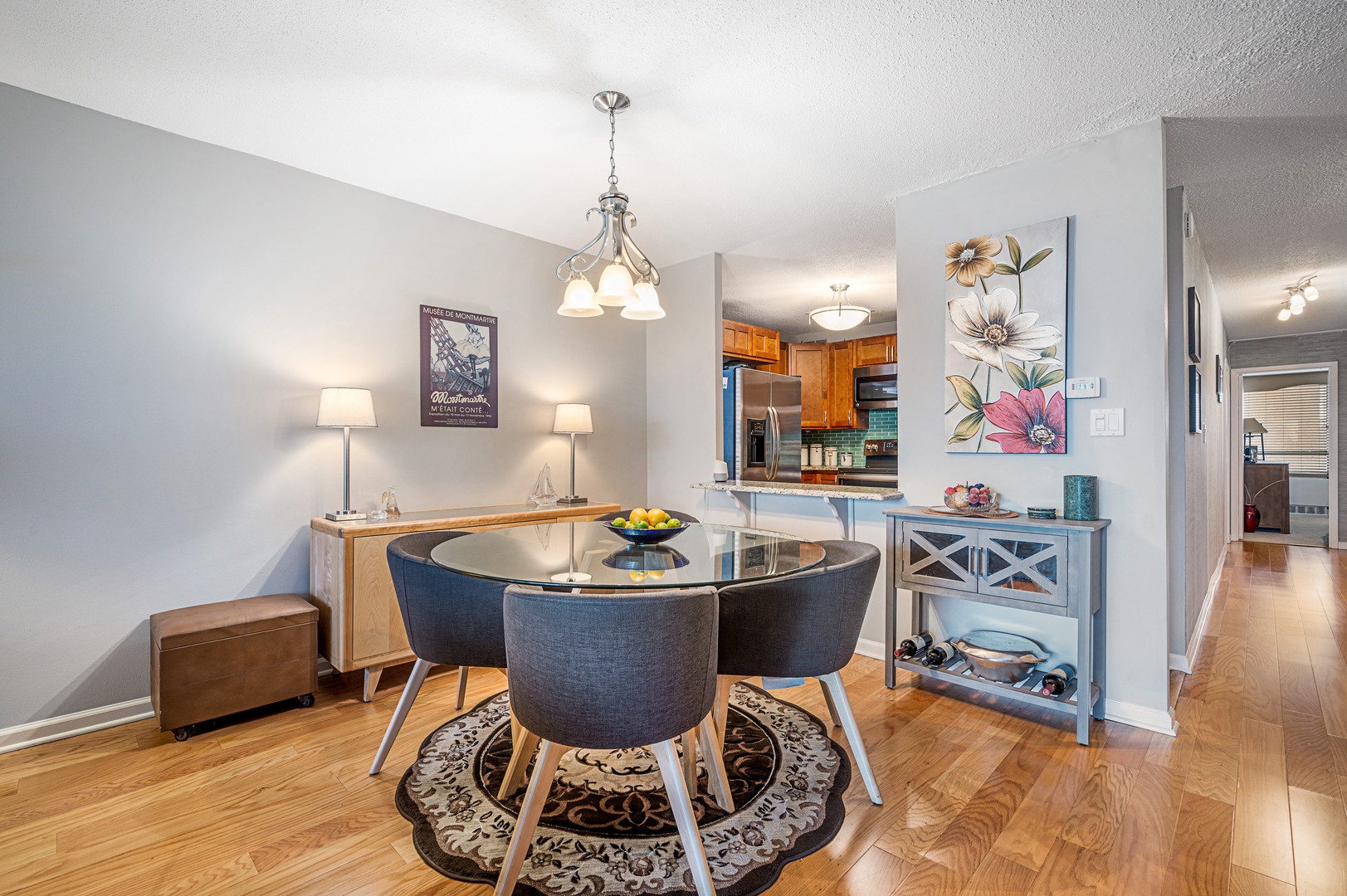 3150 North Sheridan Road, Unit 3C Chicago, IL 60657 - Photo 9 of 19 a living room with furniture a chandelier and a rug