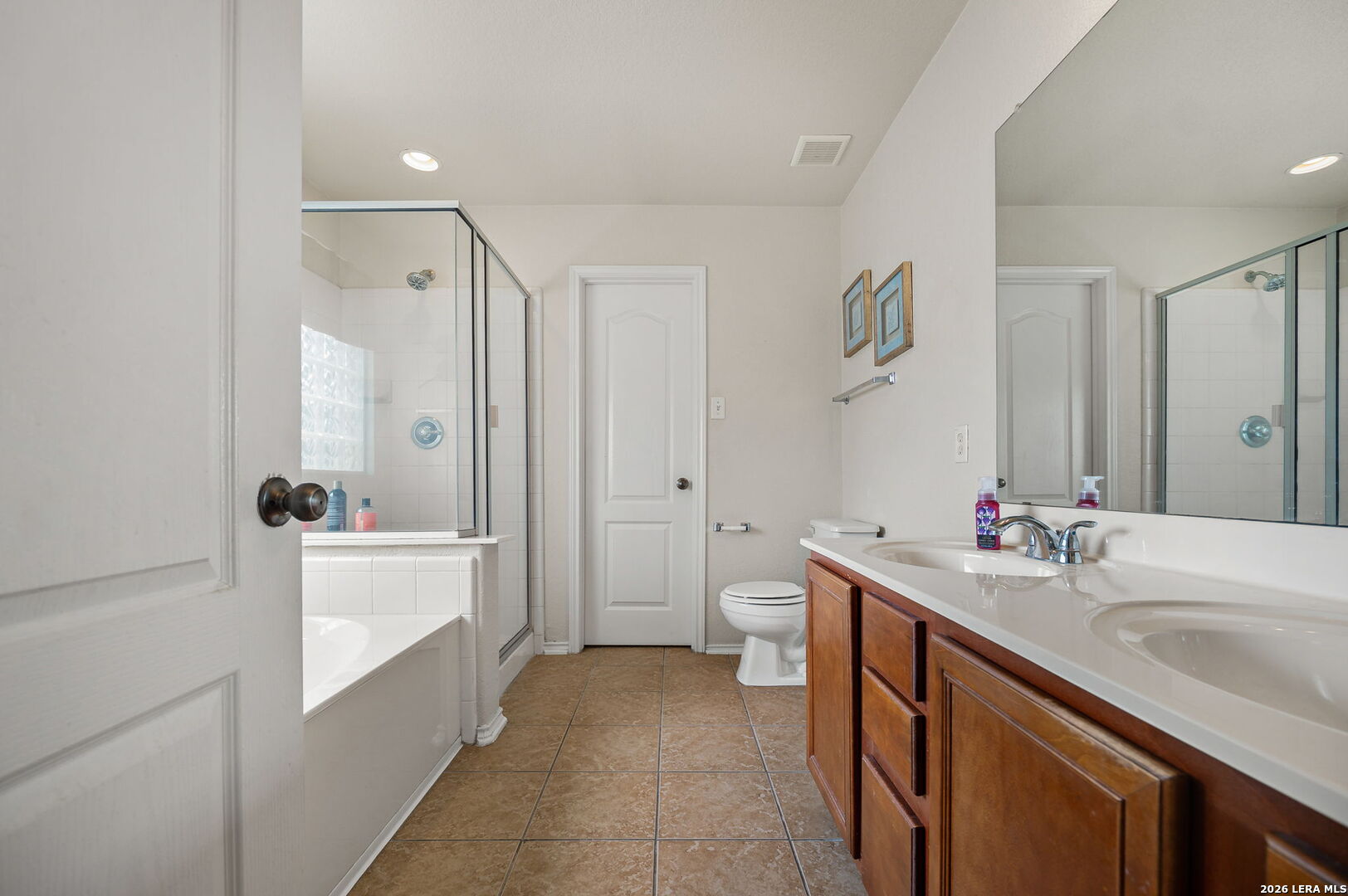 7207 Avery Road Live Oak, TX 78233 - Photo 27 of 32 a bathroom with a sink a tub and a mirror