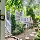 a view of a pathway of a house with potted plants