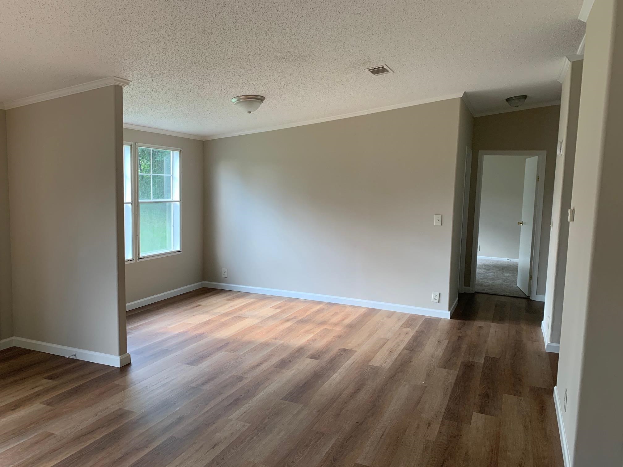 2146 Burks Road Henning, TN 38041 - Photo 8 of 21 a view of an empty room with wooden floor and a window