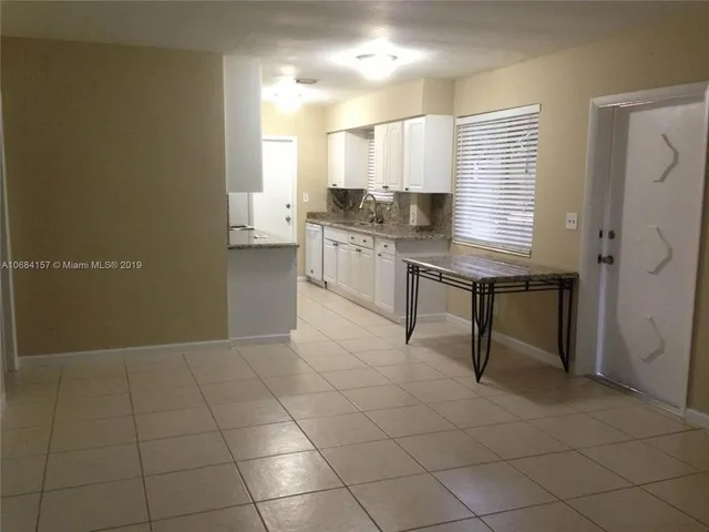 a kitchen with a sink cabinets and window