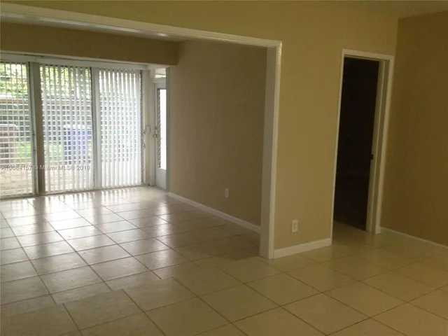 a view of a livingroom with an empty space and a window