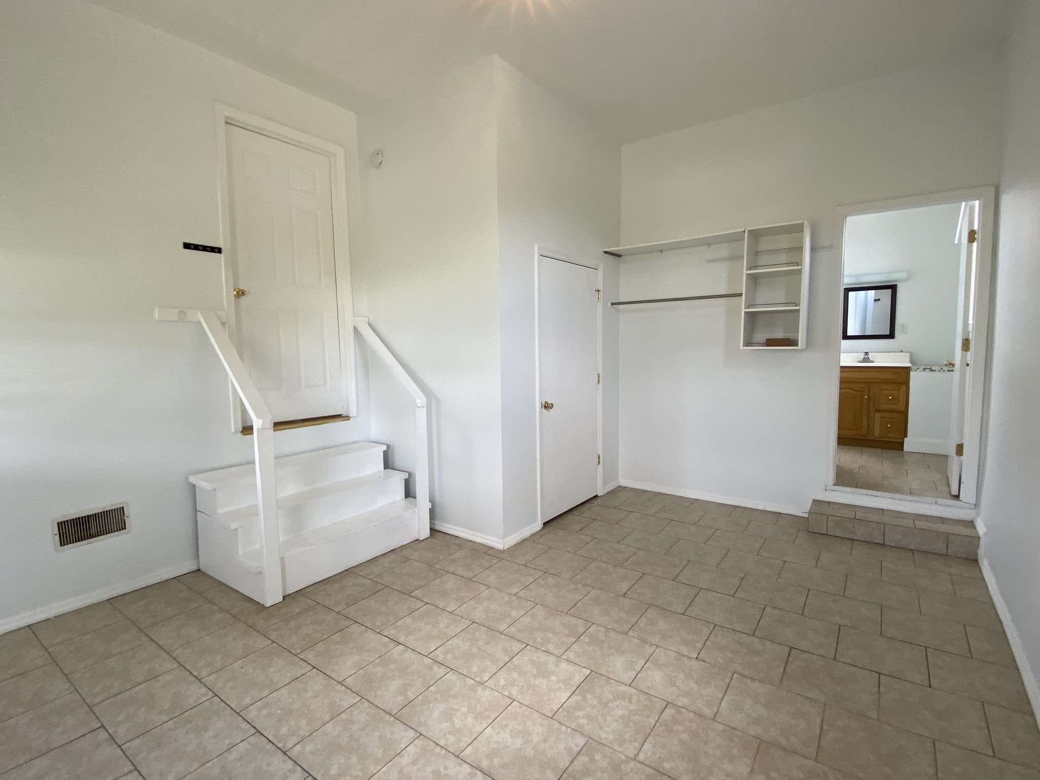 401 Whaley Street Smithville, TN 37166 - Photo 12 of 37 a view of an empty room with stairs and white cabinet