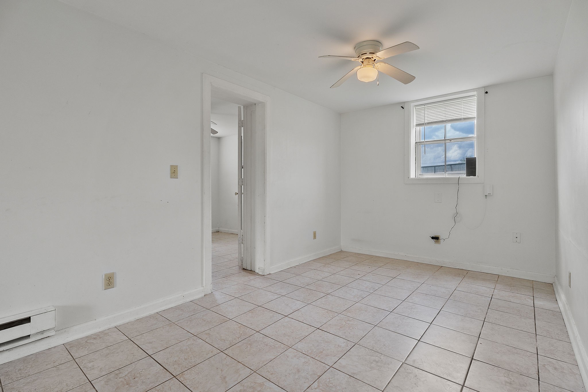 401 Whaley Street Smithville, TN 37166 - Photo 31 of 37 an empty room with white walls and ceiling fan