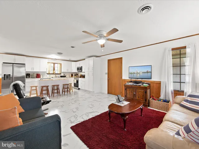 a living room with furniture a table and a flat screen tv