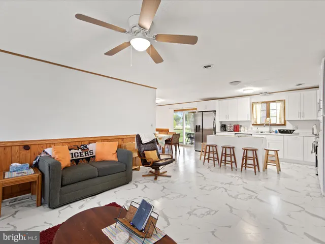 a living room with furniture kitchen view and a dining table