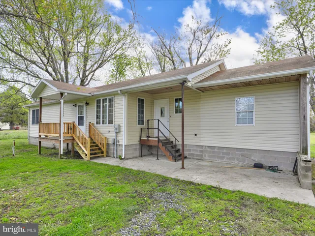a view of a house with backyard porch and sitting area
