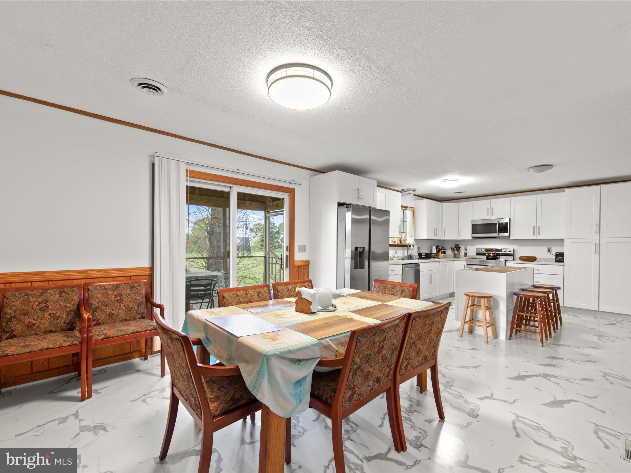 23451 Deal Island Road Deal Island, MD 21821 - Photo 21 of 49 a view of a dining room with furniture and a potted plant