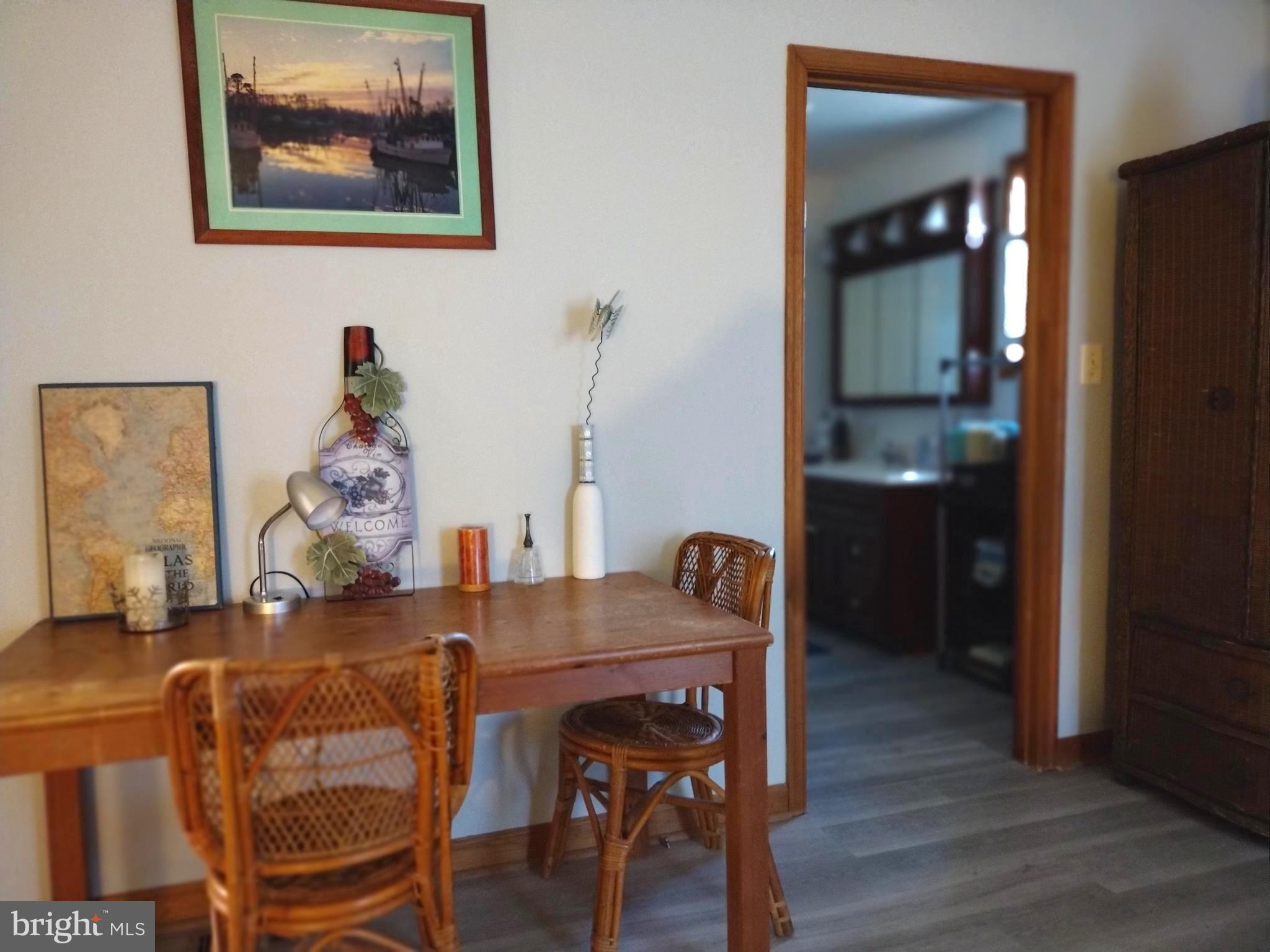 23451 Deal Island Road Deal Island, MD 21821 - Photo 27 of 49 a view of a dining room with furniture and wooden floor