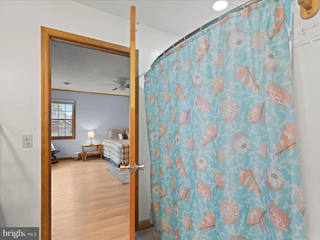 a view of a bathroom with a sink and a curtain