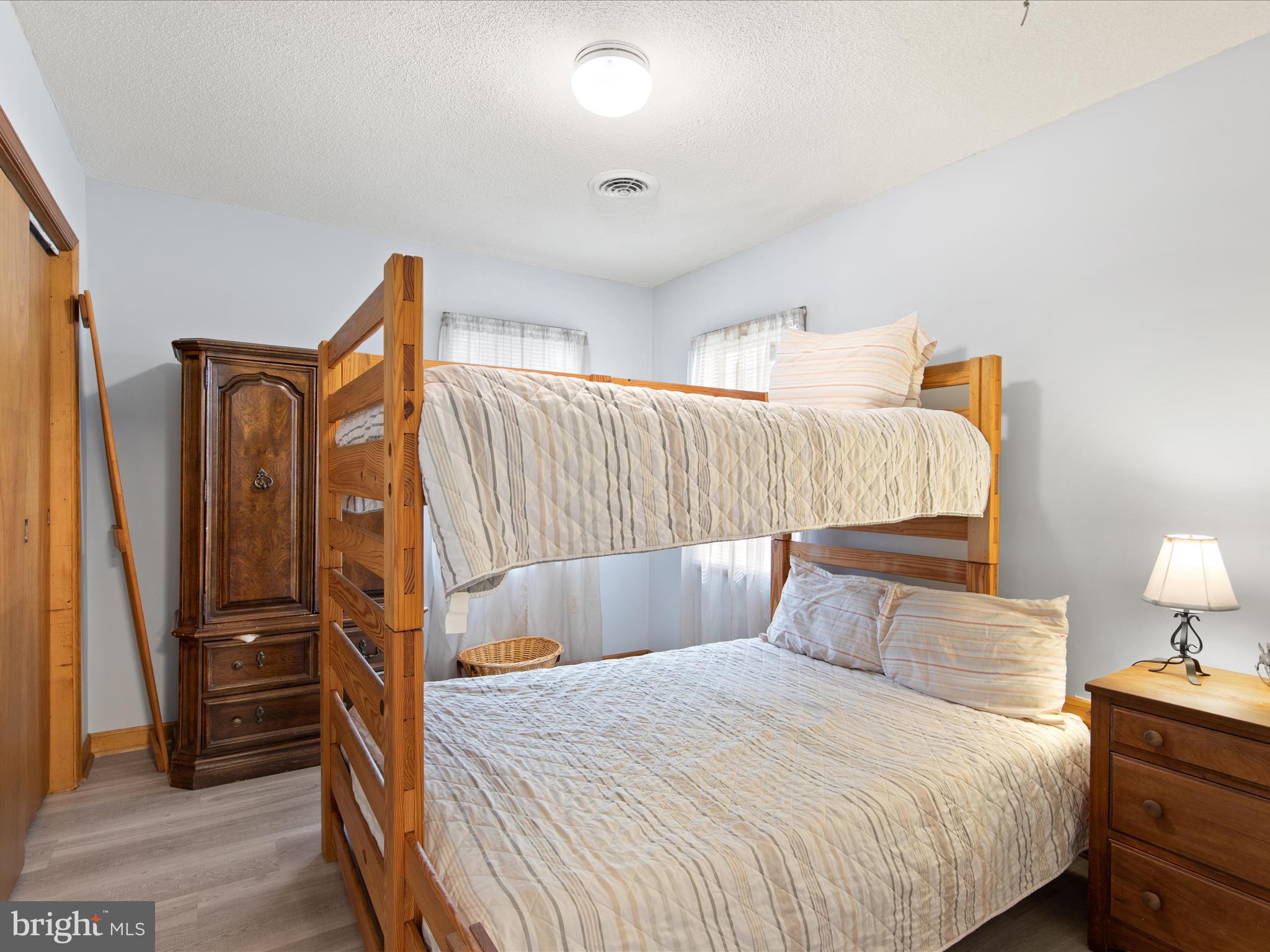 23451 Deal Island Road Deal Island, MD 21821 - Photo 32 of 49 a bedroom with a bed and wooden floor