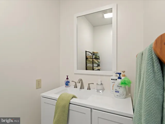 a bathroom with a sink a vanity and a mirror