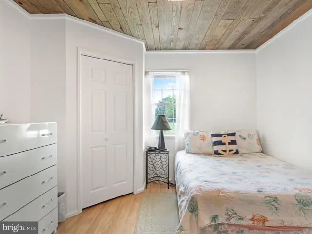 a bedroom with furniture and a flat tv screen