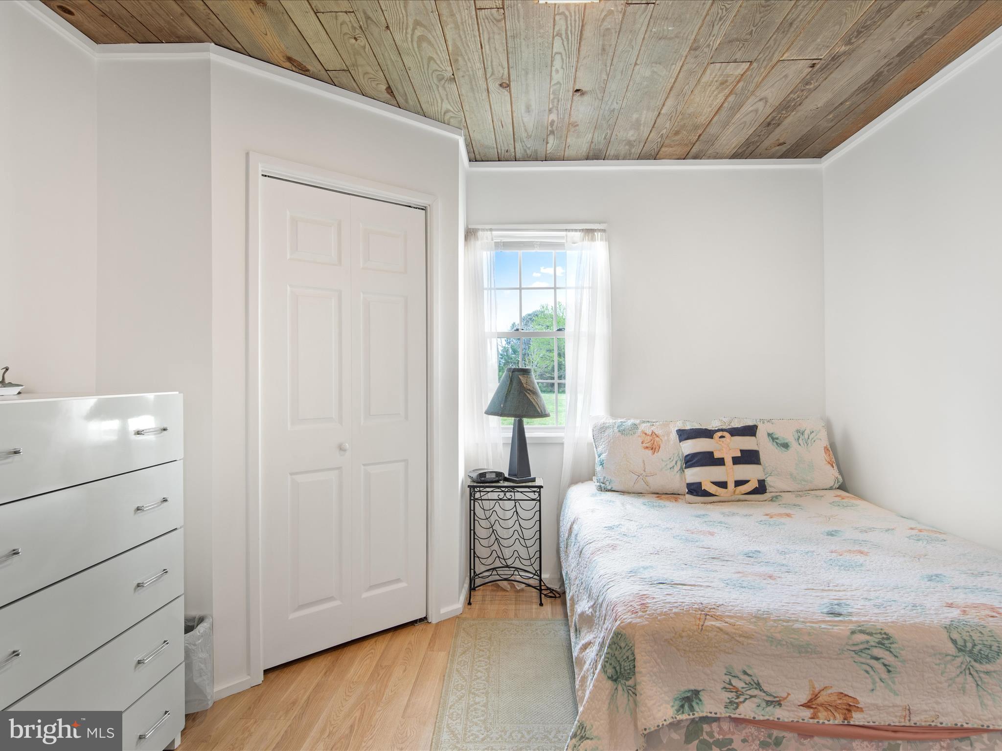 23451 Deal Island Road Deal Island, MD 21821 - Photo 38 of 49 a bedroom with a bed and a table