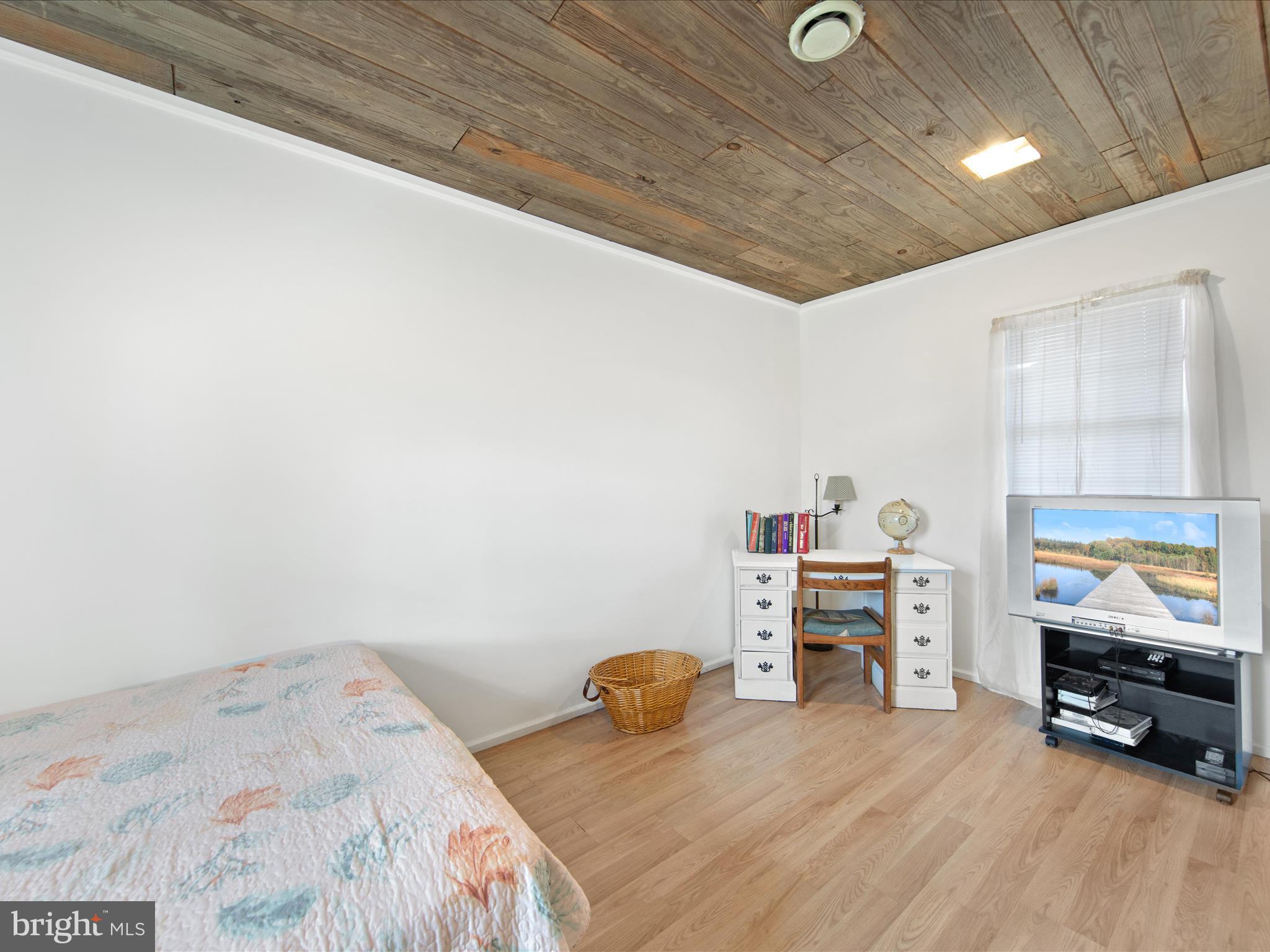 23451 Deal Island Road Deal Island, MD 21821 - Photo 39 of 49 a bedroom with furniture and a flat tv screen