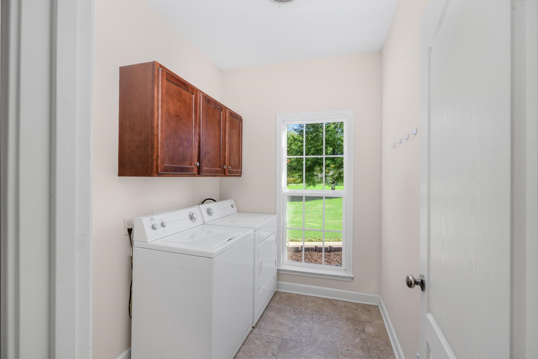 251 Rosemark Road Atoka, TN 38004 - Photo 12 of 40 Clothes washing area with independent washer and dryer, cabinets, and plenty of natural light