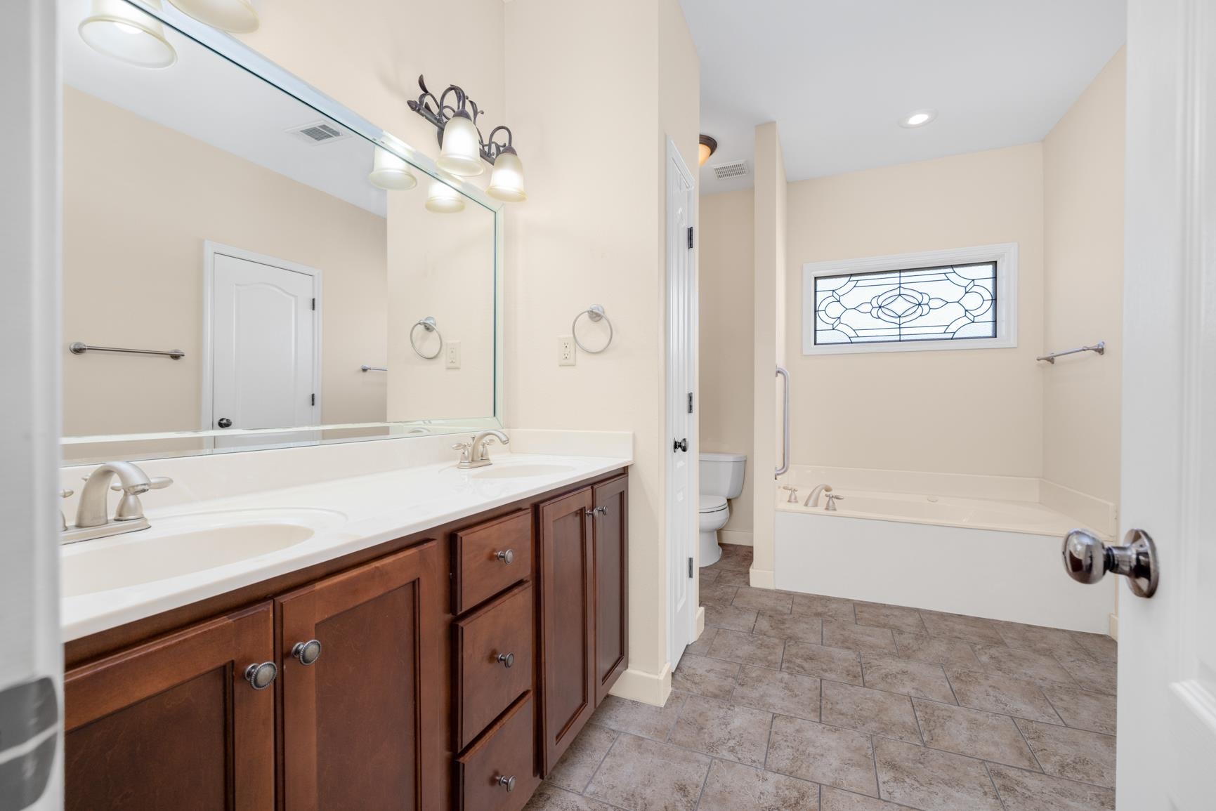 251 Rosemark Road Atoka, TN 38004 - Photo 22 of 40 Bathroom with double vanity, toilet, and a bathing tub