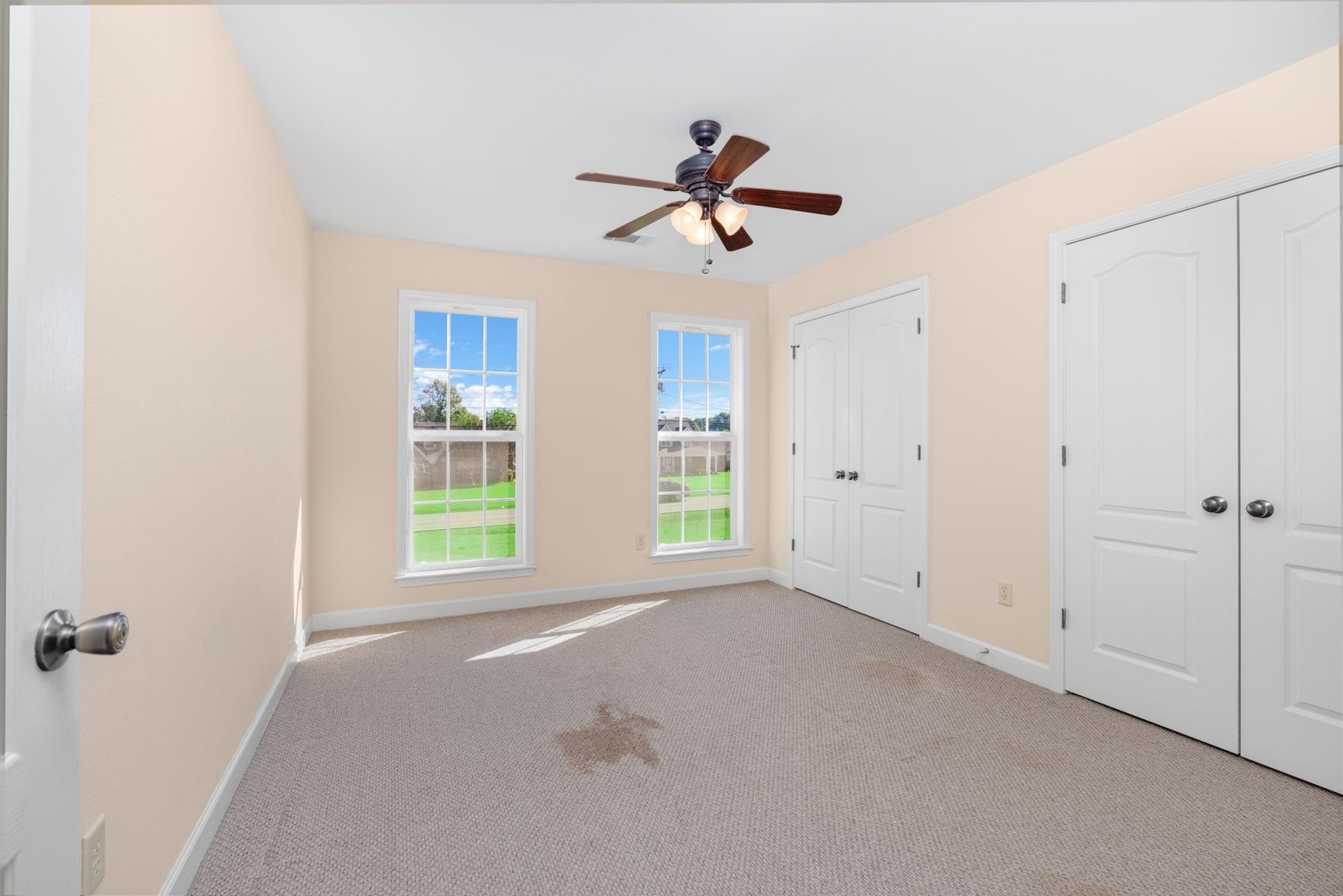 251 Rosemark Road Atoka, TN 38004 - Photo 27 of 40 Unfurnished bedroom with ceiling fan, light carpet, and two closets