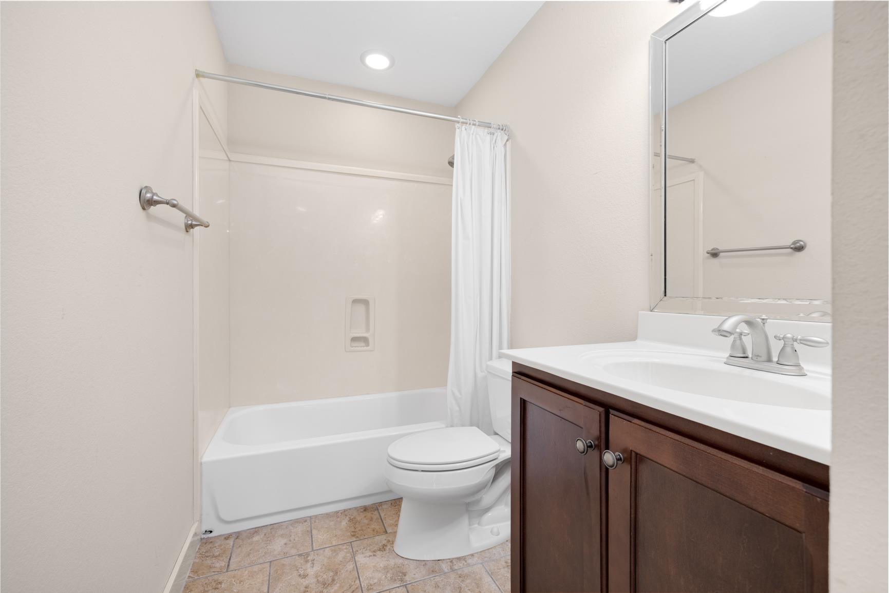 251 Rosemark Road Atoka, TN 38004 - Photo 28 of 40 Full bathroom with vanity, toilet, tile patterned floors, and shower / bath combination with curtain