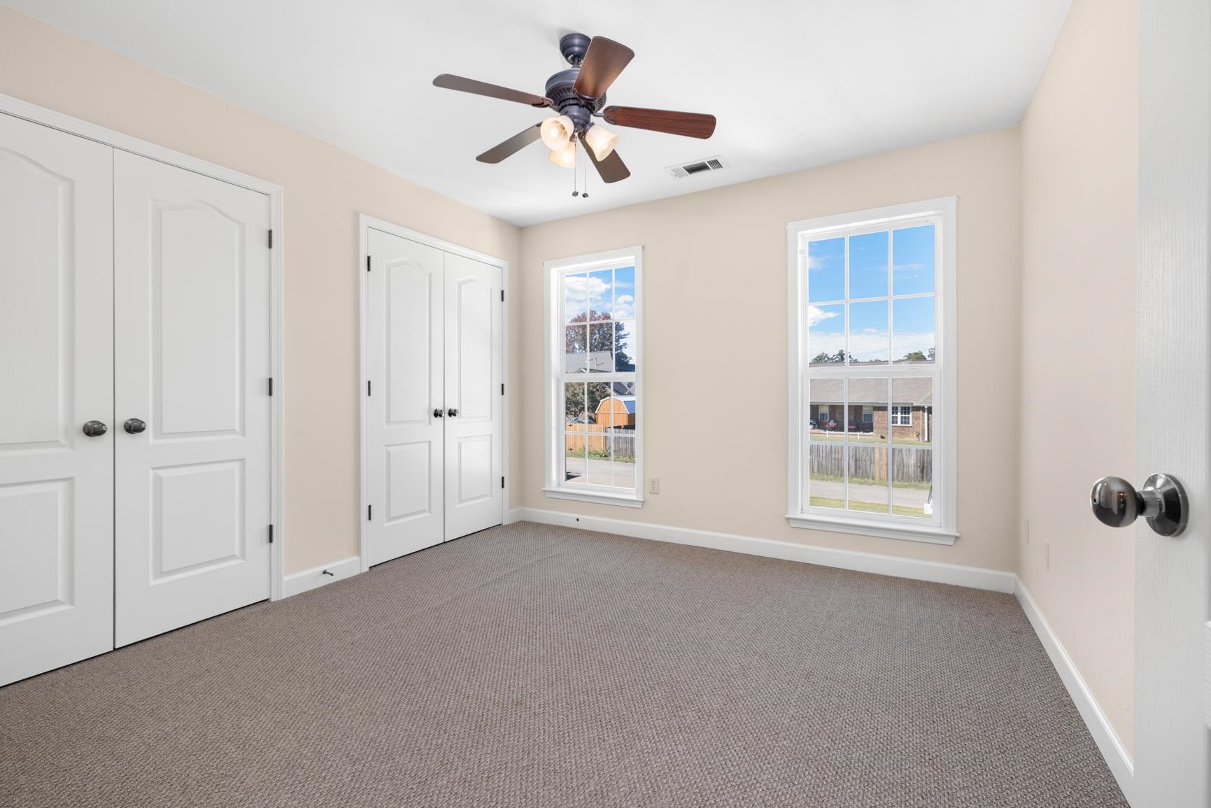 251 Rosemark Road Atoka, TN 38004 - Photo 29 of 40 Bedroom featuring multiple closets, light colored carpet, and ceiling fan