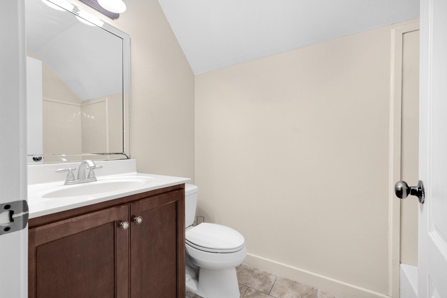 251 Rosemark Road Atoka, TN 38004 - Photo 34 of 40 Full bathroom with tile patterned floors, toilet, shower/ tub combo, vaulted ceiling, and vanity