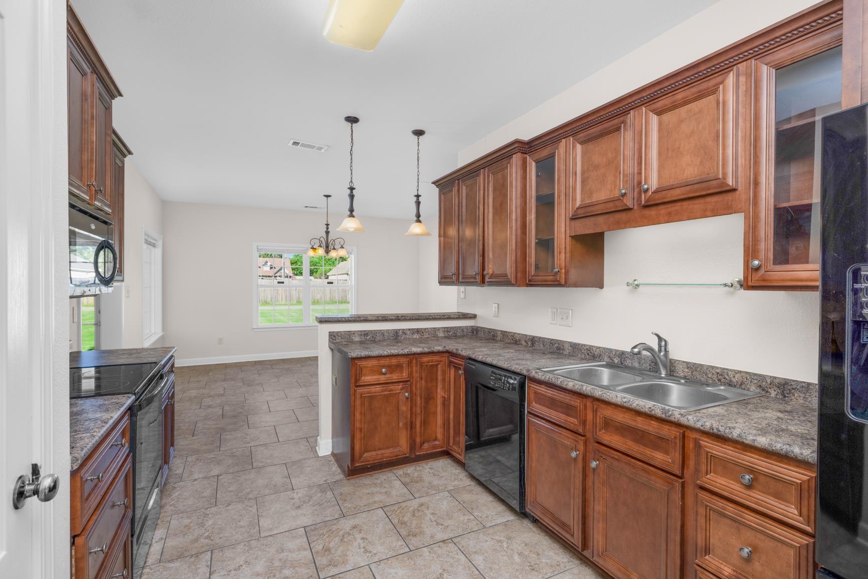 251 Rosemark Road Atoka, TN 38004 - Photo 9 of 40 Kitchen featuring black appliances, sink, and pendant lighting