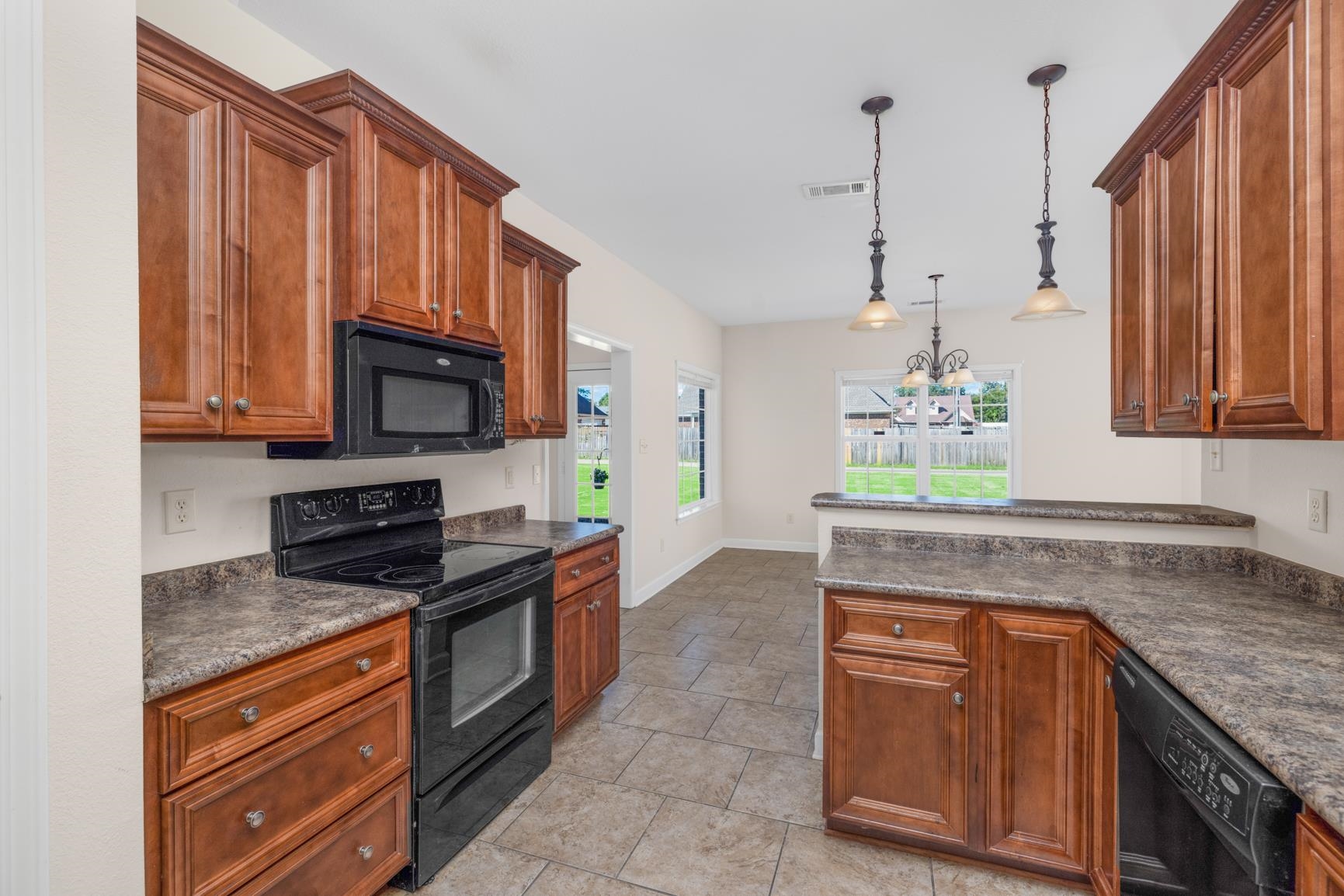 251 Rosemark Road Atoka, TN 38004 - Photo 10 of 40 Kitchen featuring a notable chandelier, black appliances, and hanging light fixtures