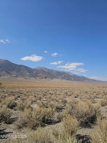 a view of an ocean beach and mountain