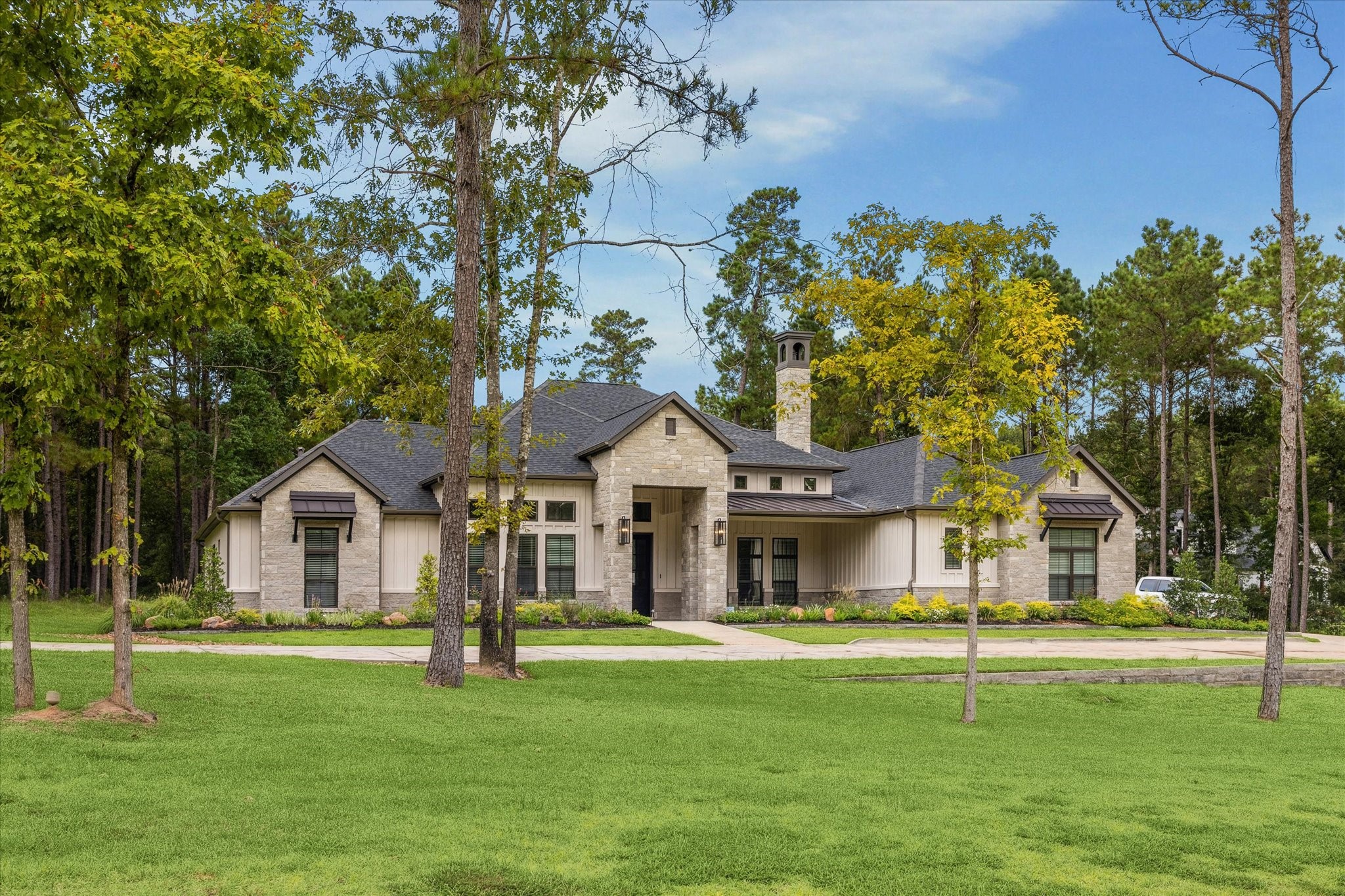 11567 Inspiration Drive Willis, TX 77378 - Photo 4 of 5 a front view of a house with a garden and trees