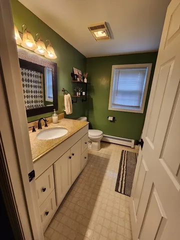 a bathroom with a sink mirror and a bathtub