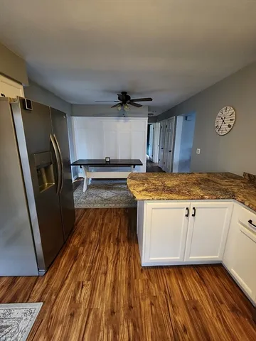 a view of a kitchen with a sink and wooden floor