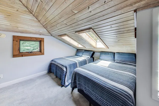 a bedroom with two beds and a window