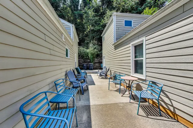 a view of a patio with couple of chairs and a couch