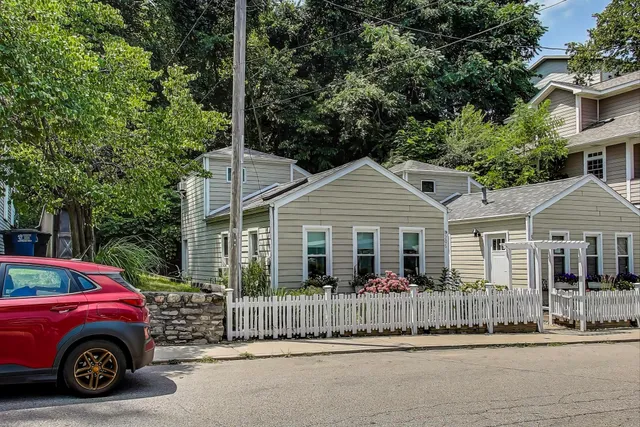 a front view of a house with a garden and plants