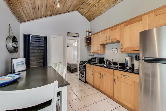 a kitchen with stainless steel appliances granite countertop a sink a stove and a refrigerator